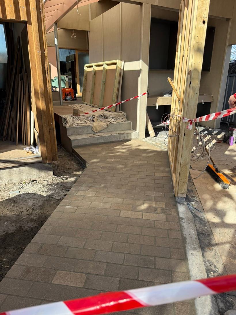 Brick paving laid along a building entry