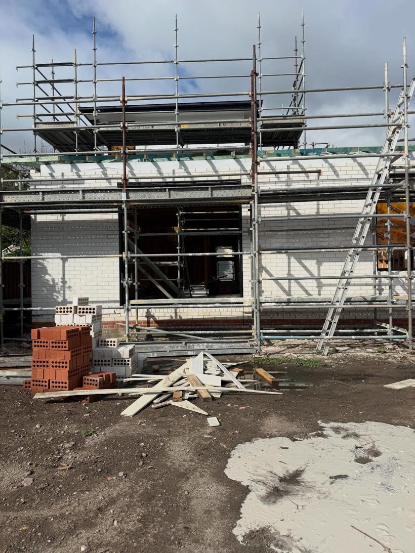 Two-storey home with brick veneer under scaffolding