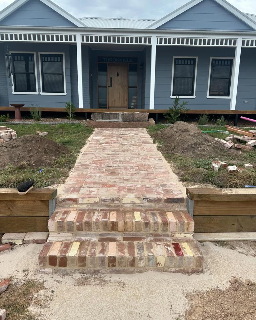 Finished recycled-brick front steps and path to a cottage
